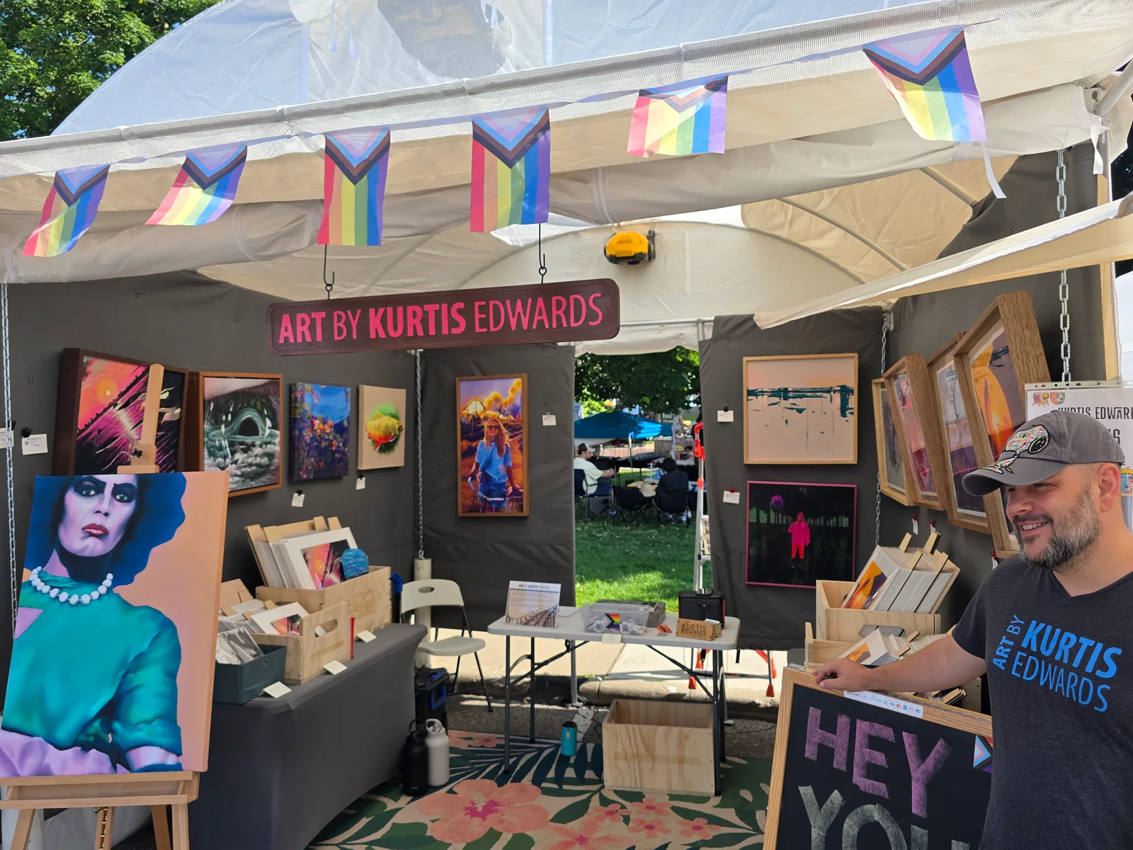 Kurtis in front of his booth at Art in the Park 2026